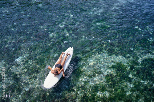 Extreme Water Sport. Surfing. Young Surfer Girl Lying on Surf Board  In Clear Water, Top View. Summer Vacation. Lifestyle. Leisure, Hobby, © luengo_ua
