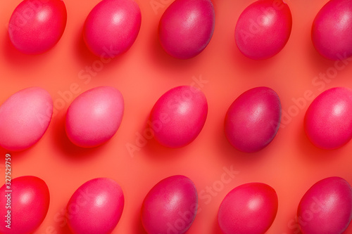 creative layout made of red easter eggs on red background