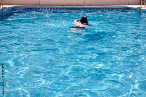 person swimming in the pool