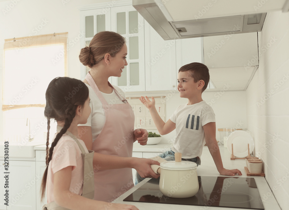 Happy family cooking together in kitchen at home Happy family cooking together in kitchen at home