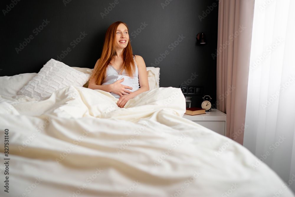 Happy healthy pragnancy. Young pregnant woman relaxing in bedroom at home. Happy healthy pragnancy. Young pregnant woman relaxing in bedroom at home.