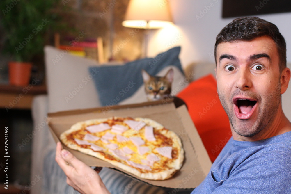 Enthusiastic man enjoying pizza at home Enthusiastic man enjoying pizza at home