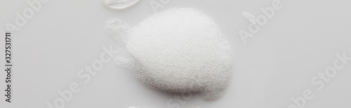 Top view of soap foam on grey background, panoramic shot