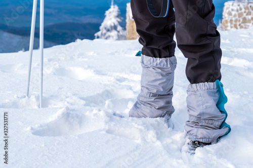 Man feet tourist protection trekking mountain snow winter sky blue equipment hiking