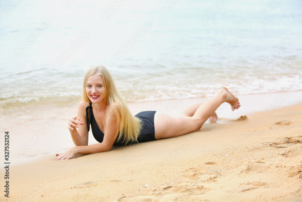 Fashion and Glamour Portrait of pretty beautiful fashion woman in black bikini posing in summer near the sea and sunset sky in evening,tropic island girl on vacation Fashion and Glamour Portrait of pretty beautiful fashion woman in black bikini posing in summer near the sea and sunset sky in evening,tropic island girl on vacation