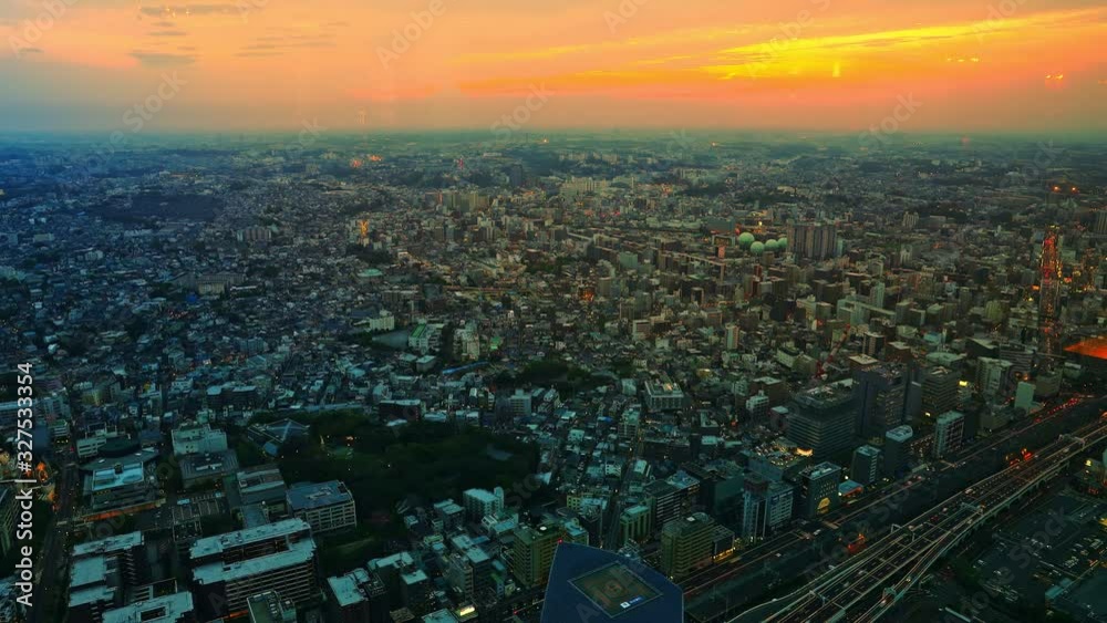 Yokohama sunset cityscape, skyscrapers and Yokohama skyline at Minato Mirai waterfront district over the port at eveing from viewing platform, observatory sky garden of Landmark Tower. TIMELAPSE