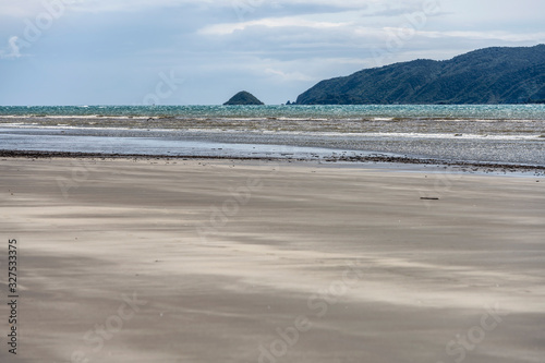 waves of Cook strait and Kapiti island in distance, Paraparaumu beach, Wellington, New Zealand photo