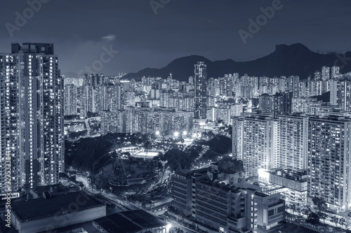 Lion Rock Hill and high rise residential building in Hong Kong city at night © leeyiutung