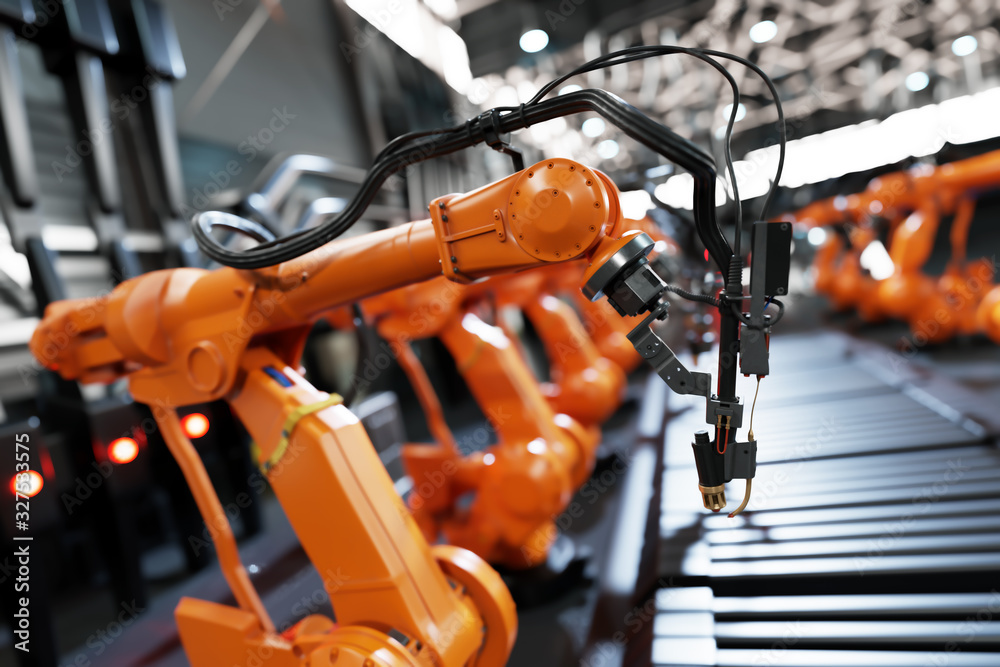 Fototapeta premium Robotic arms along assembly line in modern factory.