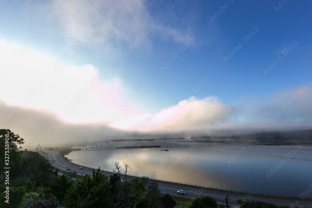 misty morning sunrise over knysna lagoon