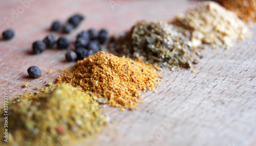 Bunches of spices on a wooden board.