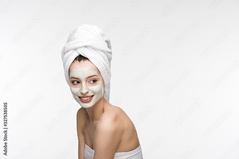 cheerful girl with facial nourishing mask and towel on head looking away isolated on white cheerful girl with facial nourishing mask and towel on head looking away isolated on white