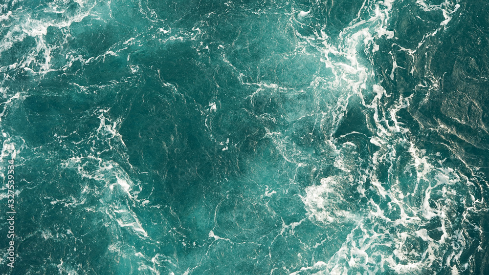 Background of the sea, clean deep ocean with air bubbles, foam on the surface of the ocean. foam composition on blue turquoise water. Background of the sea, clean deep ocean with air bubbles, foam on the surface of the ocean. foam composition on blue turquoise water.