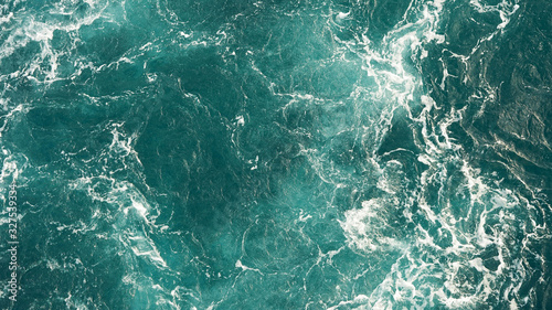 Background of the sea, clean deep ocean with air bubbles, foam on the surface of the ocean. foam composition on blue turquoise water.