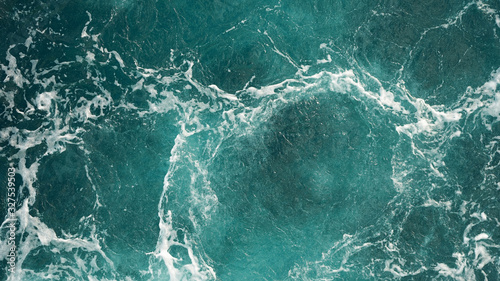 Fototapeta Naklejka Na Ścianę i Meble -  Background of the sea, clean deep ocean with air bubbles, foam on the surface of the ocean. foam composition on blue turquoise water.