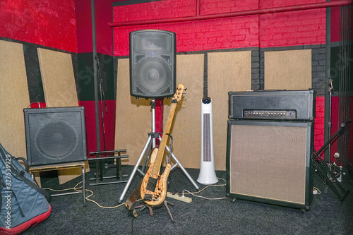 View of rehearsal room, speakers, and bas guitar photo