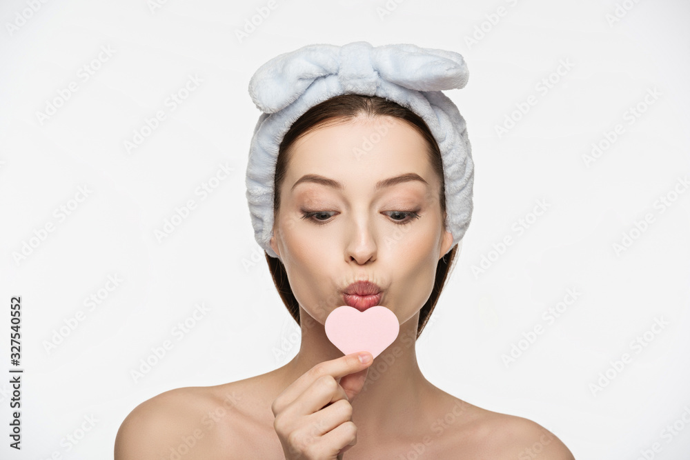 attractive girl kissing heart-shaped cosmetic sponge isolated on white attractive girl kissing heart-shaped cosmetic sponge isolated on white