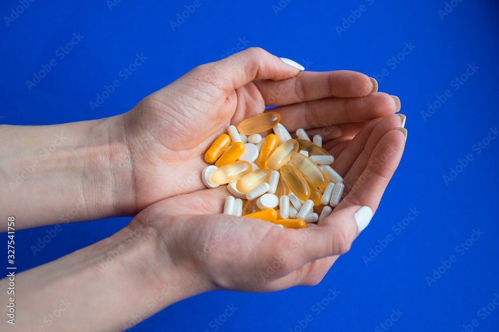 Assorted pills on a blue background. Medication. thermometer. Flu Prevention. coronavirus mask Assorted pills on a blue background. Medication. thermometer. Flu Prevention. coronavirus mask