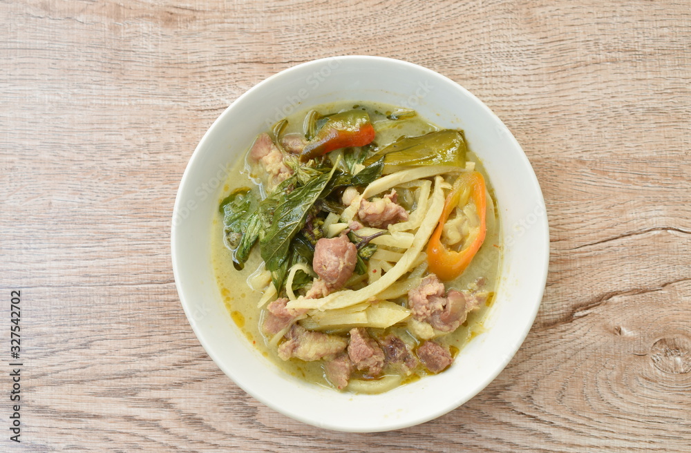 spicy boiled slice bamboo shoot with pork in coconut milk green curry soup on bowl spicy boiled slice bamboo shoot with pork in coconut milk green curry soup on bowl