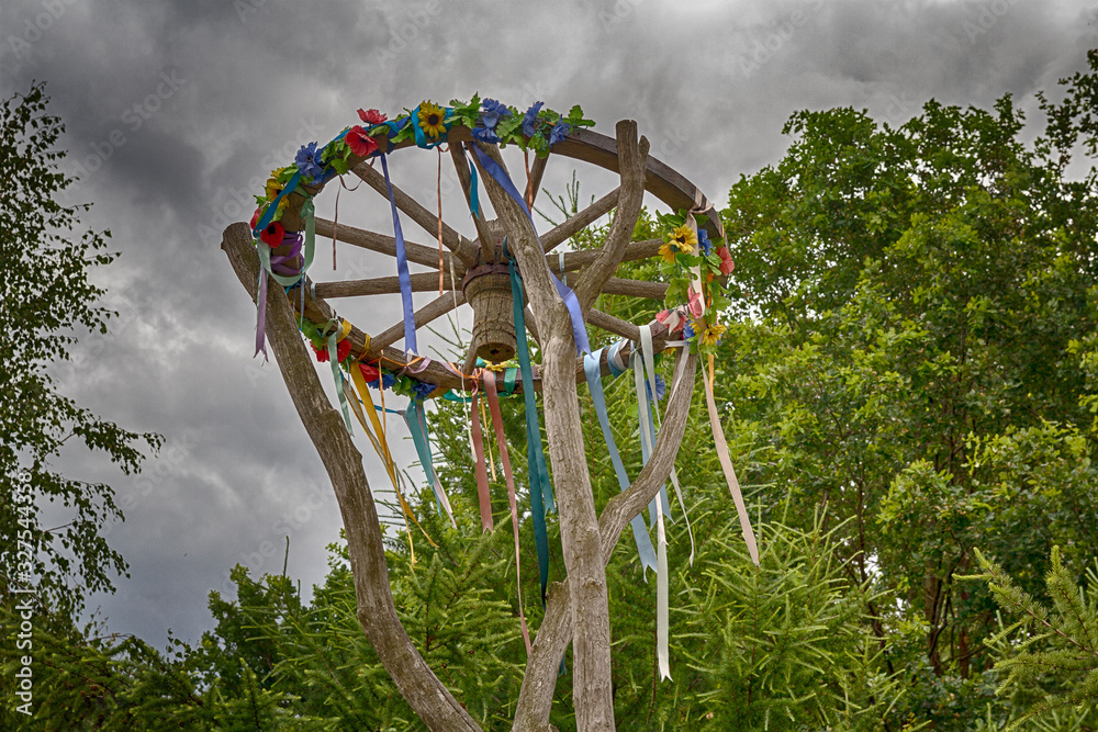 Wooden wheel with bright ribbons. Slavic celebration of Midsummer