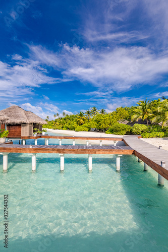 Exotic landscape of Maldives beach. Tropical panorama, luxury water villa resort with wooden pier or jetty. Luxury travel destination background for summer holiday and vacation concept.