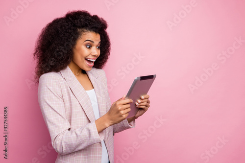 Profile photo of amazing excited dark skin business lady hold e-book hands young professional read startup information statistics wear plaid blazer isolated pink pastel color background