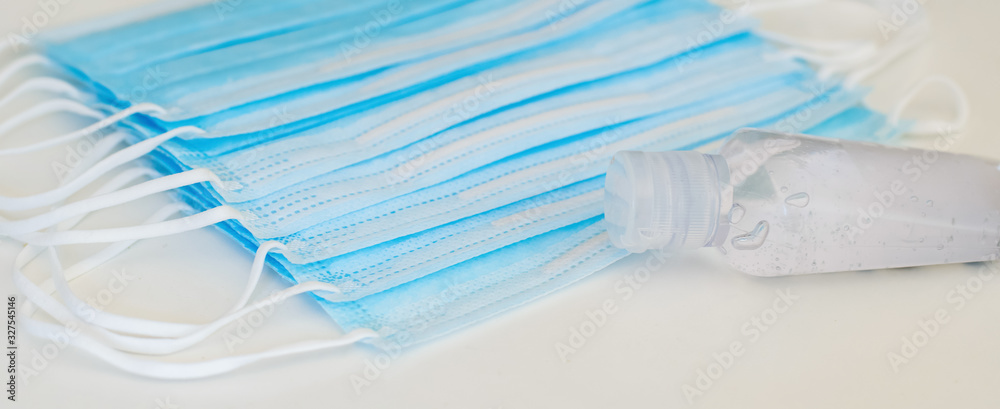 Disposable mask and hand sanitizer to prevent viruses spreading and protect yourself from influenza Disposable mask and hand sanitizer to prevent viruses spreading and protect yourself from influenza