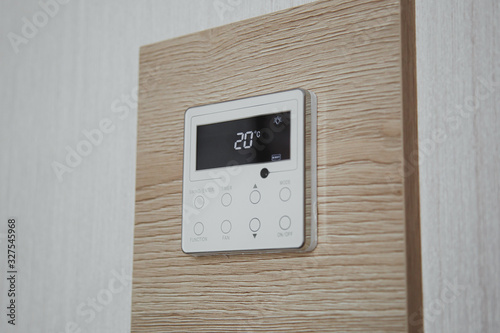 air conditioner screen on the wall that shows an air temperature of 20 degrees Celsius photo