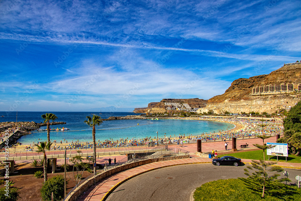 sunny landscape with the picturesque colorful Amadores beach on the Spanish Canary Island of Gran Canaria