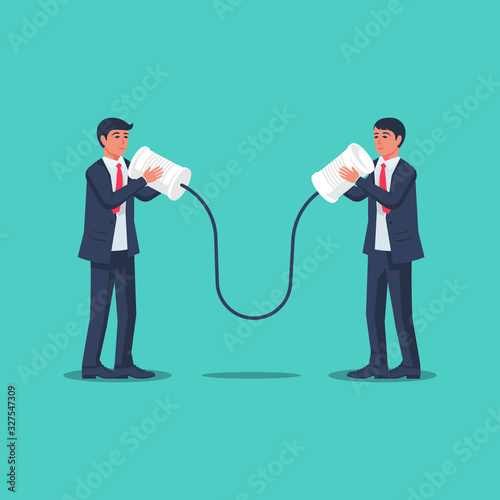 Businessmen communicate using tin cans. Business communication concept. Vector illustration flat design. Isolated on background. People talking on can phone. Discussion of questions. photo