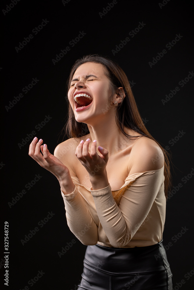 Portrait of brunette Woman screaming on black background Portrait of brunette Woman screaming on black background