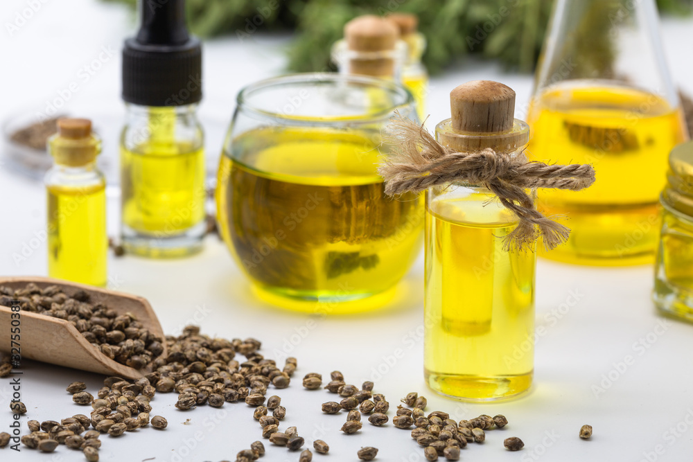 Hemp seeds and hemp oil, CBD cannabis oil extract, marijuana alternative herbal medicine concept. Hemp seeds and hemp oil, CBD cannabis oil extract, marijuana alternative herbal medicine concept.