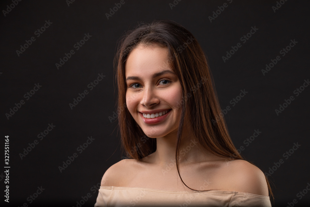 close up portrait of beautiful smiley woman over black background close up portrait of beautiful smiley woman over black background