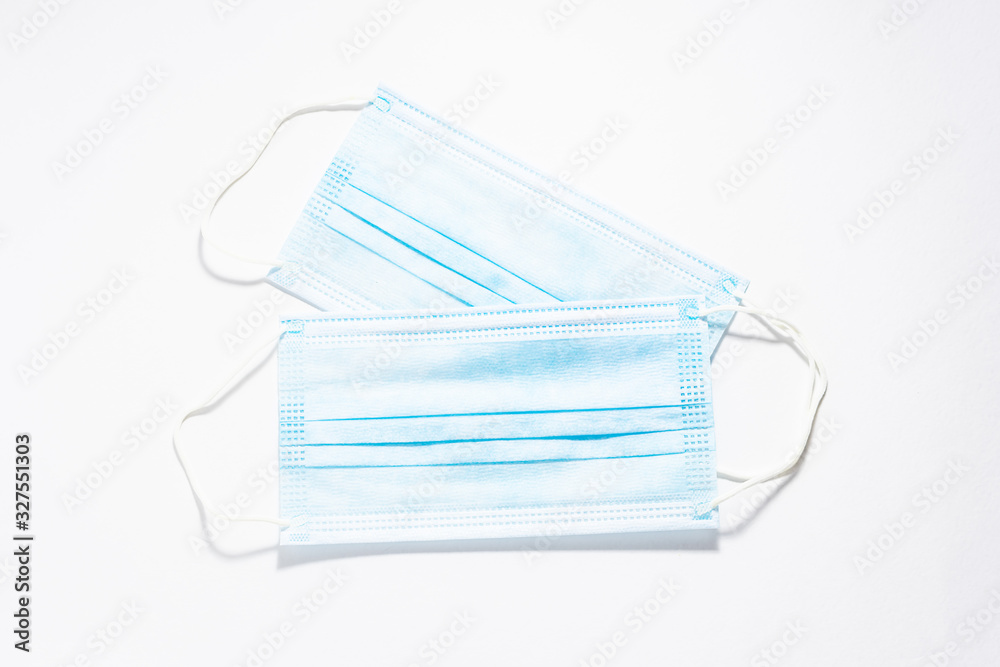 Two sterile medical masks on white background top view. Infection prevention concept. Two sterile medical masks on white background top view. Infection prevention concept.