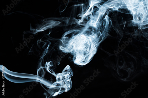 Photo of a wisp of smoke on a dark background photo