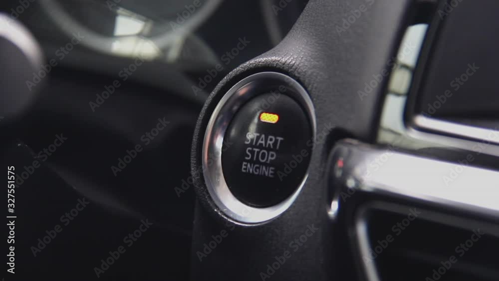 Starting car engine. Track in to the button. Finger press the button to start the car engine