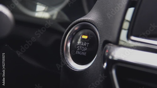 Starting car engine. Track in to the button. Finger press the button to start the car engine