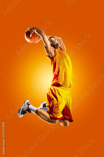 bright professional basketball player on an orange background