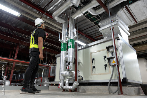 Technician daily pressure check controls system for security functions in utility room at factory. CHR-CHS system