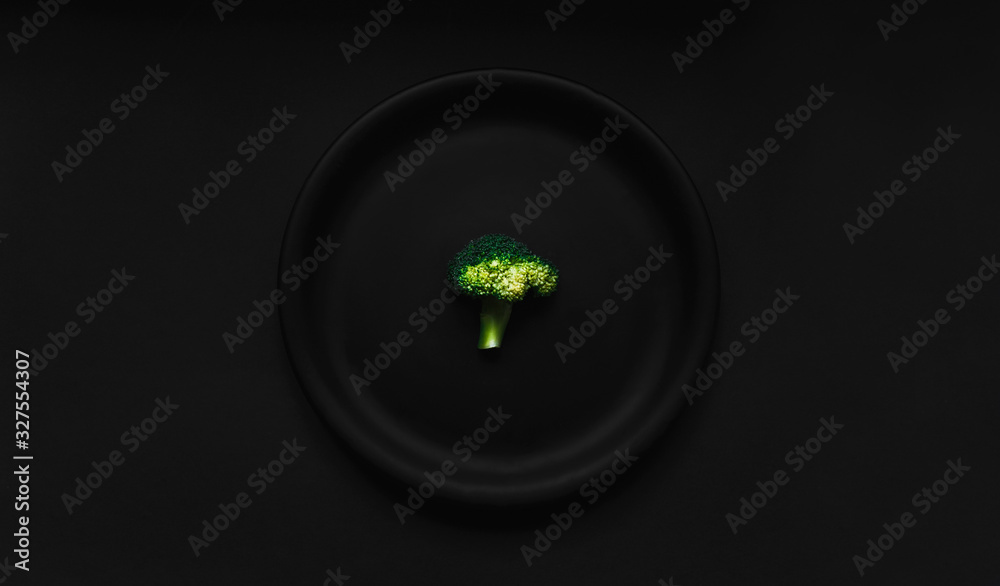Broccoli in black plate on dark black background. Top view, flatlay and healthy diet concept. Broccoli in black plate on dark black background. Top view, flatlay and healthy diet concept.