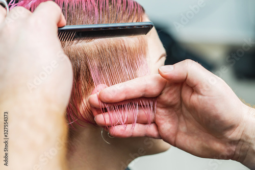 Close up combing hair of woman.