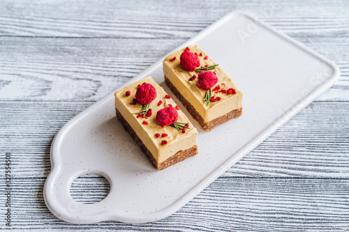 Mango cake. Freeze-dried raspberries and nuts. Raw dessert. Vegetarian healthy food