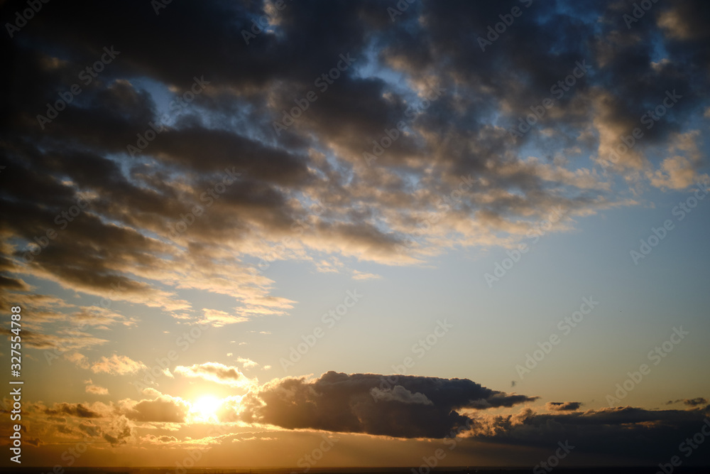 Altocumulus, cirrus and cumulus clouds on the sky at sunset, background, copy space for text