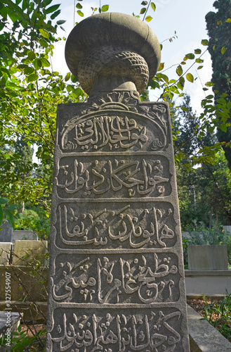 Historic grave stones with Ottoman Turkish script in Karacaahmet Cemetery in the Uskudar district of Istanbul. It is the oldest cemetery in Istanbul and the biggest burial ground in Turkey photo