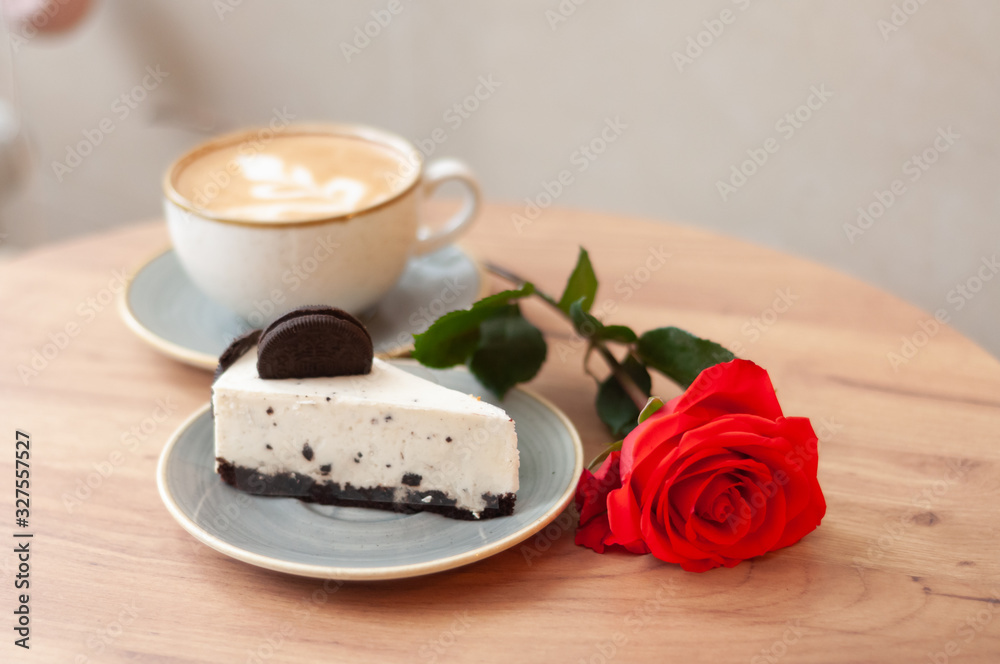 cup of coffee, cake and rose on a wooden table cup of coffee, cake and rose on a wooden table