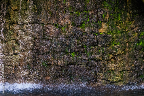 Water running down a stone wall as a part of a fountain in Grasse (France) © k.dei
