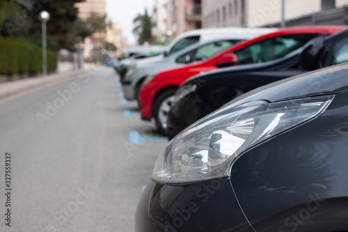 All parking spaces on the street are occupied by cars. © Albina