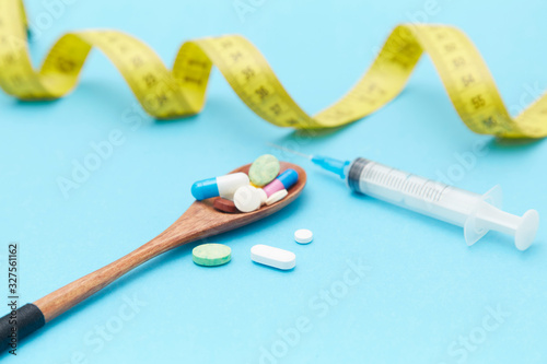 Diet pills, syringes, rulers and other weight-loss materials placed on the table