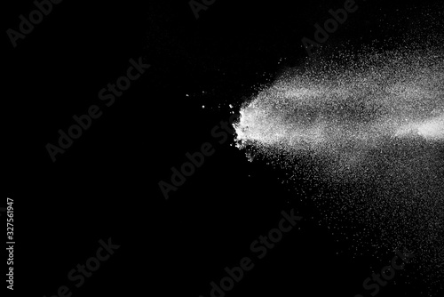 Explosion of white sand on black background. © piyaphong