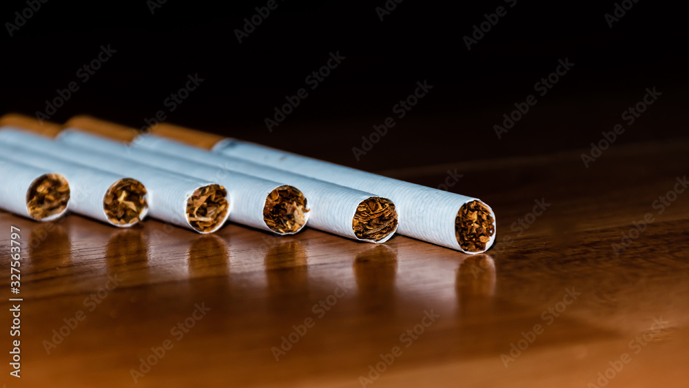 A close-up shot of six cigarettes lying on the table A close-up shot of six cigarettes lying on the table